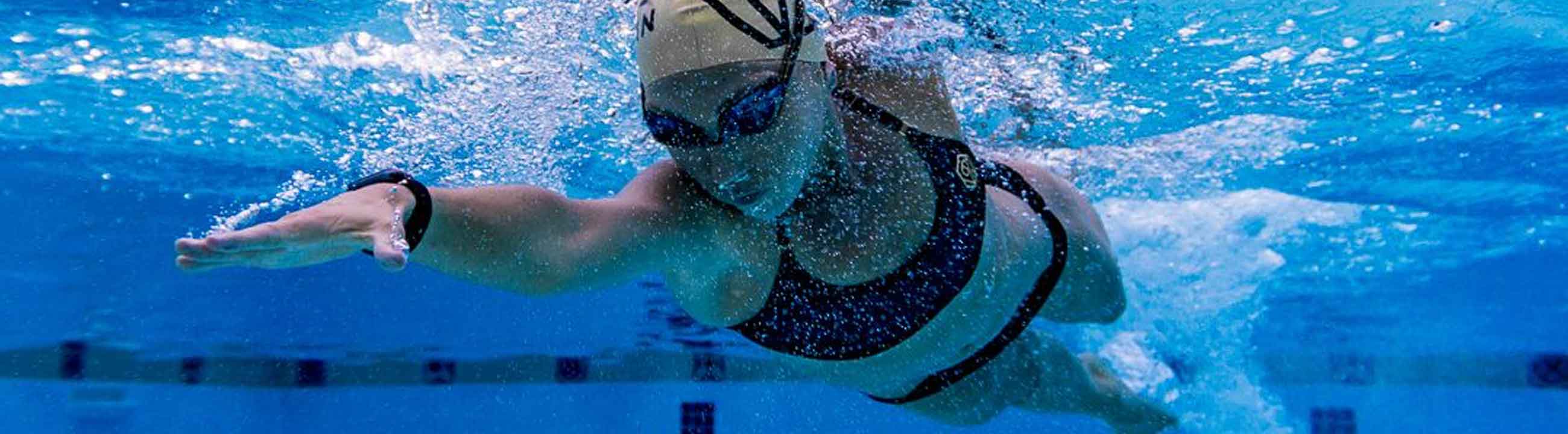 Underwater view of a professional swimmer training in a pool wearing a bikini